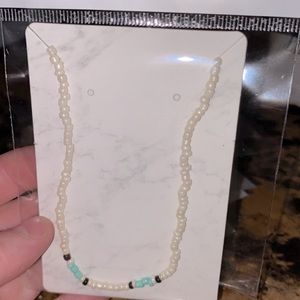Hand made white, black, and turquoise necklaces.
